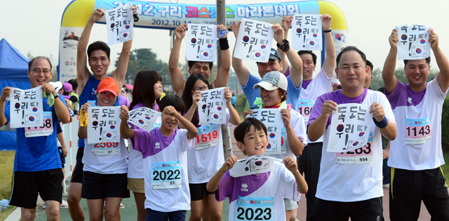 2012 구리 코스모스 마라톤대회가 열린 14일 구리 한강시민공원에서 한 단체 참가자들이 '독도는 우리땅'이라는 문구를 들어보이고 있다. 추상철기자 scchoo@kyeonggi.com