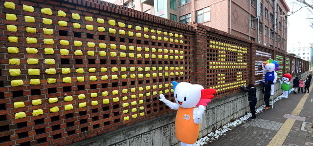 6.4 지방선거를 세달 앞둔 9일 수원 권선고등학교에서 권선구 선거관리위원회가 학교 담장에 지방선거 공식 슬로건 '나와 가족을 위해 투표로 응원하세요!'란 문구를 새겨 넣고 있다. 권선구 선관위는 지방선거에 대한 관심과 참여유도, 공정하고 깨끗한 선거문화 정착을 위해 이벤트를 마련했다. 추상철기자 scchoo@kyeonggi.com
