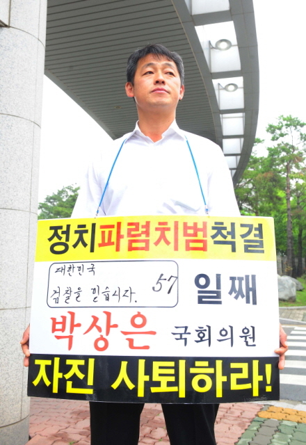 7일 오전 정치 자금법 위반 등의 혐의를 검찰조사를 받기 위해 새누리당 박상은(인천 중구·동구·옹진군) 국회의원이 인천지검에 출두한 시각에 박의원의 전 비서인 장관훈씨가  지검 정문 앞에서 자진사퇴를 요구하는 1인 시위를 하고 있다. 장용준기자 jyjun68@kyeonggi.com