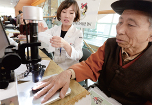 ▲ 11월 11일 수원 장안구민회관 한누리아트홀에서 열린 ‘행복한 100세 건강법’ 행사에서 한 어르신이 건강관리협회가 마련한 ‘검진 부스’에서 각종 무료검진을 받고 있다