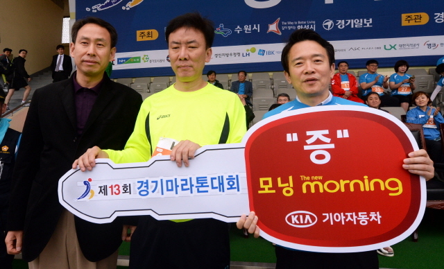 경기도와 수원시, 화성시, 경기일보가 공동주최한 제13회 경기마라톤대회가 열린 19일 수원종합운동장에서 경품 1등 기아자동차 모닝을 받은 참가자가 남경필 경기지사와 기념촬영을 하고 있다. 추상철기자