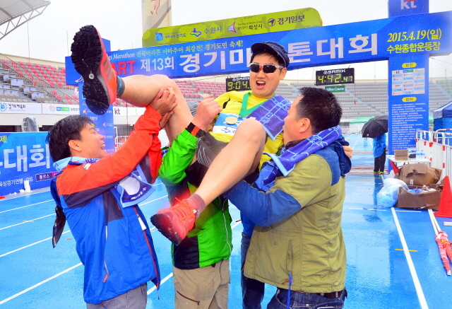 19일 수원종합운동장에서 열린 '제13회 경기마라톤 대회'에서 구미 전자공고 출신 풀코스 완주자가 동기들로부터 헹가레를 받고 있다. 김시범기자