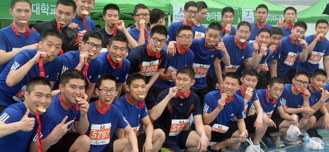 경기도와 수원시, 화성시, 경기일보가 공동주최한 제13회 경기마라톤대회가 열린 19일 수원종합운동장에서 용인대학교 군사학과 학생들이 완주 메달을 입에 물고 기념촬영을 하고 있다. 추상철기자