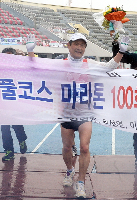 경기도와 수원시, 화성시, 경기일보가 공동주최한 제13회 경기마라톤대회가 열린 19일 수원종합운동장에서 100회 마라톤 완주자가 결승선을 통과하고 있다. 추상철기자
