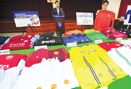 ▲ 23일 오전 1천억원 상당의 짝퉁 해외 유명 축구단의 유니폼을 적발하고 판매업체 대표를 구속한 인천본부세관 직원들이 청사내 대강당에서 압수품들을 살펴보고 있다. 장용준기자