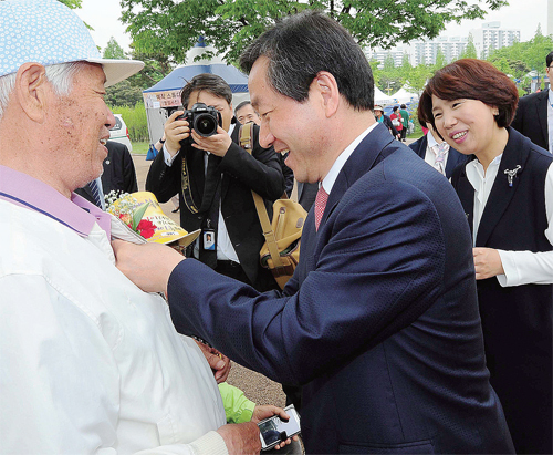 ▲ 공식 행사에 앞서 유정복 인천시장 내외가 어르신들에게 카네이션을 달아 드리고 있다.