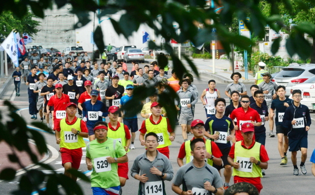 12일 오전 제65주년 9.15 인천상륙작전 전승기념 마라톤대회가 열린 인천시 중구 월미도 순회도로에서 일반부와 장병부 참가 선수들이 힘차게 달리고 있다. 김시범기자