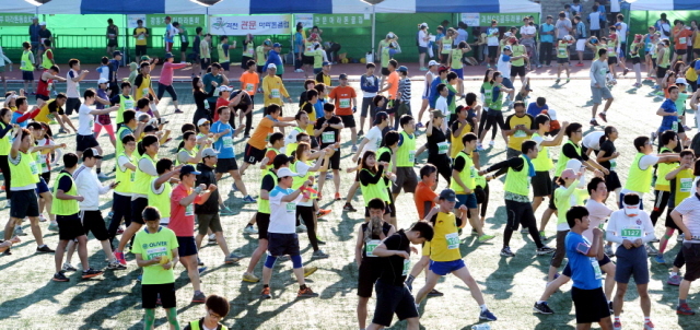 13일 과천 관문체육공원 운동장에서 열린 ‘2015 과천 마라톤 대회’에서 참가자들이 출발에 앞서 몸풀기 운동을 하고 있다.전형민기자