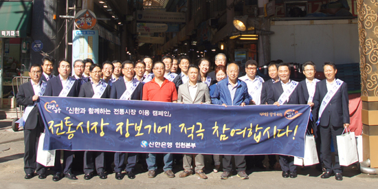 ▲ 신한은행 직원들이 전통시장 장보기 행사를 마치고 기념쵤영을 가졌다. 신한은행 제공