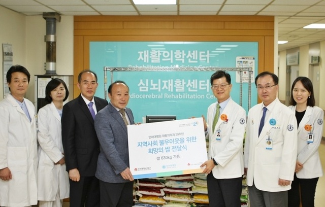 ▲ 김명옥 인하대병원 재활의학과장(오른쪽 세번째)이 최근 인하대병원에서 최중용 중구 주민생활지원과장(왼쪽 네번째)에게 쌀 630㎏을 기증하고 기념촬영을 하고 있다. 인하대병원 제공