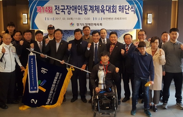 ▲ 30일 수원 라메르아이에서 열린 제14회 전국장애인동계체육대회 경기도선수단 해단식에서 선수 및 지도자, 관계자들이 준우승기와 준우승배를 들고 기념촬영을 하고 있다.홍완식기자