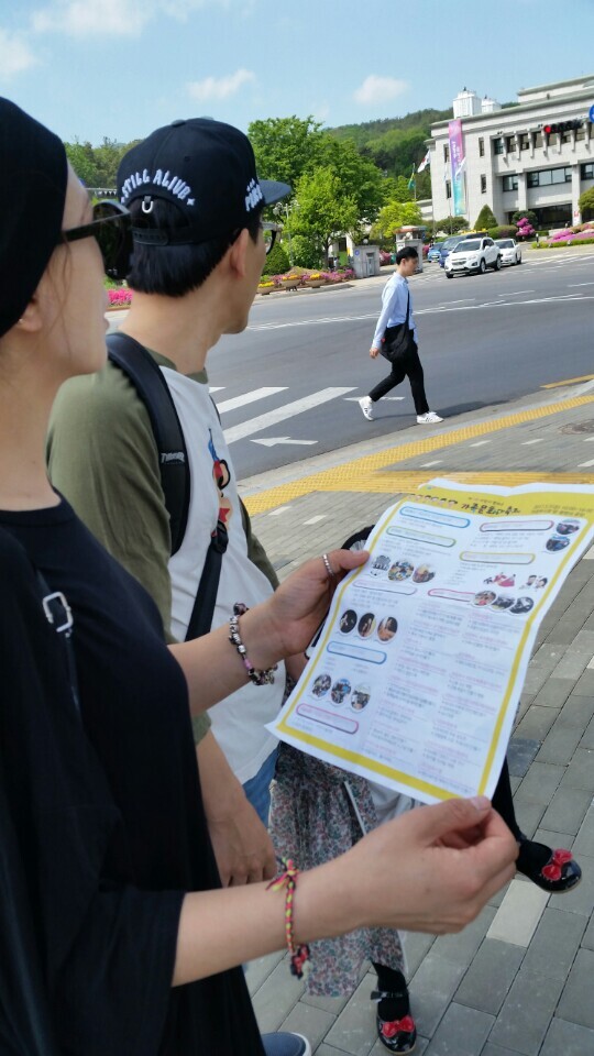 ▲ 행사연기를 뒤 늦게 안 부부가 홍보물을 들여다 보고 있다. l