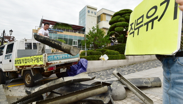 ▲ 28일 오전 인천시 중구 중구청 앞에서 인천녹색연합 회원들이 중구 영종도 서쪽 갯벌(용유해변)에서 수거한 칠게잡이 불법 어구를 내던지며 어구 철거를 촉구하는 퍼포먼스를 하고 있다.장용준기자