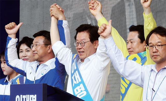 ▲ 더불어민주당 이재명 경기도지사 후보가 11일 구리시 돌다리사거리에서 안승남 구리시장 후보 등과 손을 들어 인사하며 유권자들에게 한표를 호소하고 있다. 김시범기자