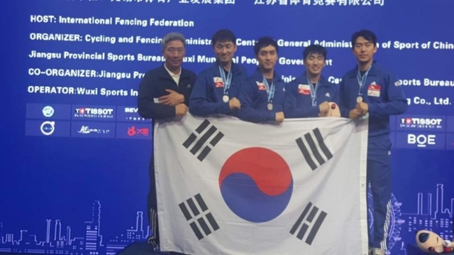 ▲ 2018 세계펜싱선수권대회에서 3년 만에 단체전 준우승을 차지한 한국 남자 에페 대표팀 양달식 감독과 선수들이 태극기를 펼쳐들고 기념촬영을 하고 있다.대한펜싱협회 제공