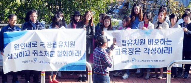 ▲ 24일 화성오산교육지원청 앞에서 서동탄 파크시티 입주 예정자들이 아파트 단지에 국,공립유치원을 원안대로 설립하고, 취소 처분을 철회할 것을 촉구하고 있다.전형민기자