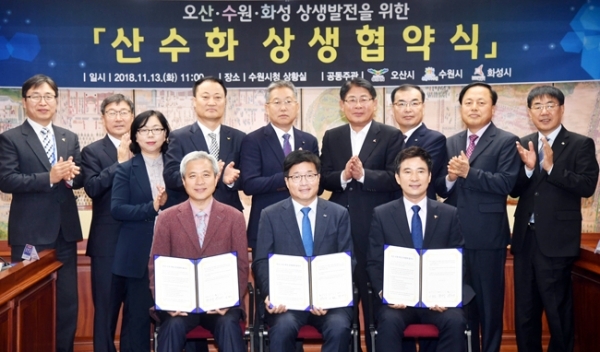 13일 수원시청 상황실에서 열린 오산ㆍ수원ㆍ화성 공동번영을 위한 ‘산수화 상생협약식’에서 (왼쪽부터) 곽상욱 오산시장, 염태영 수원시장, 서철모 화성시장이 협약서에 서명 후 참석자들과 기념촬영을 하고 있다.전형민기자