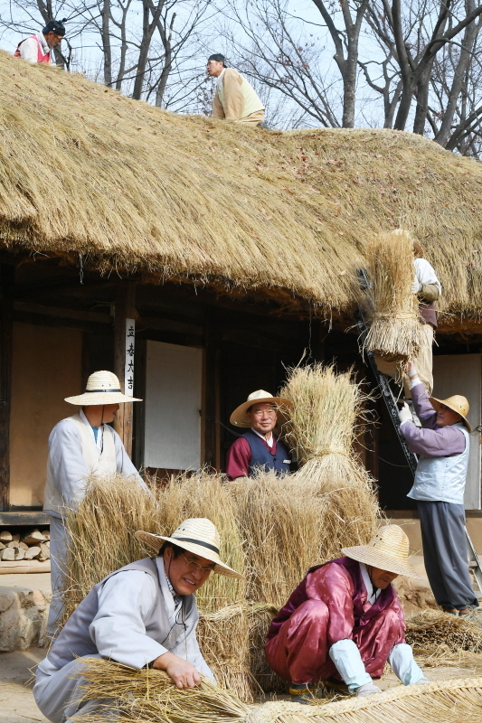 18일 용인 한국민속촌에서 관계자들이 초가지붕에 올릴 용마름과 이엉 잇기 작업을 하며 월동준비를 하고 있다. 조태형기자