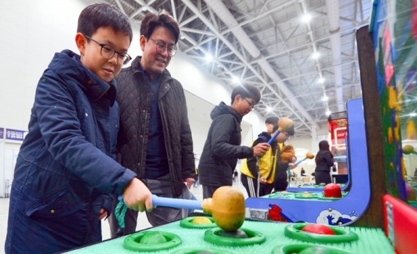 한 어린이가 아빠와 함께 게임존에서 두더지잡기 게임을 하고 있다. 조주현 기자