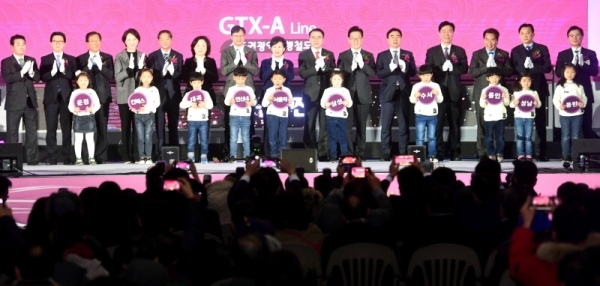 27일 고양시 킨텍스에서 열린 ‘수도권광역급행철도(GTX) A노선 착공식’에서 김현미 국토교통부 장관, 유은혜 사회부총리 겸 교육부 장관, 이재명 경기도지사 등 참석자들이 열차 모형 앞에서 A노선 역명이 적힌 소품을 들고 착공기념 축하 세리머니를 하고 있다.전형민기자