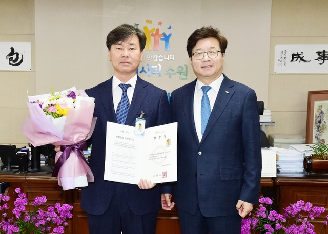 박동일 수원시 인권담당관(왼쪽)이 임용 후 염태영 수원시장과 기념촬영을 하고 있다. 수원시제공