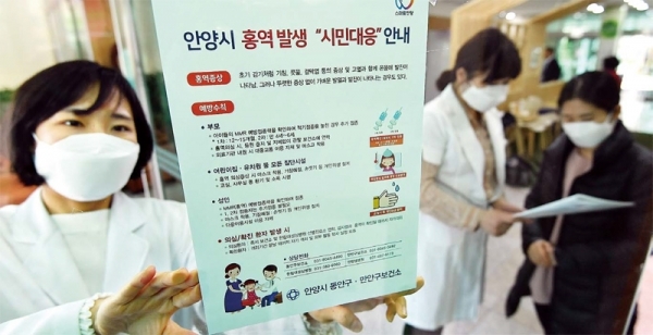 안양의 한 병원에서 홍역 확진환자가 18명으로 늘어나면서 안양시가 확산을 막기 위해 총력을 기울이고 있다. 4일 만안구보건소에서 관계자가 ‘홍역 발생 시민대응 안내문’을 붙이고 있다. 시는 이날부터 지역 내 학교, 아파트, 전철역 등 다중이용 시설에서 안내문과 마스크를 나눠주며 홍역 예방 캠페인에 돌입했다. 김시범기자