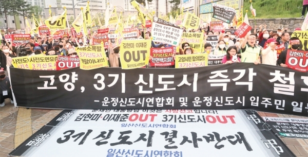 12일 파주시 운정행정복지센터 앞에서 고양 일산신도시 연합회와 파주 운정신도시 연합회•인천 검단신도시 연합회 주민들이 집회를 열고 3기 신도시 계획을 규탄하는 구호를 외치고 있다. 연합뉴스