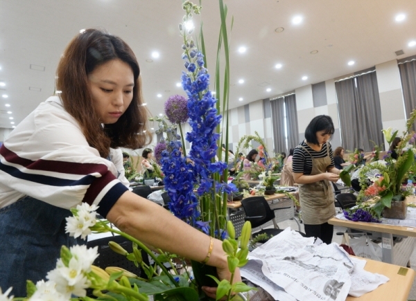 도내 여성들이 예술적 기량과 재능을 발휘할 수 있는 `제 34회 경기여성 기예경진대회`가 15일 용인시 기흥구의 경기여성의전당에서 열렸다. 꽃꽂이 부문 참가자들이 꽃들을 다듬고 있다. 윤원규기자