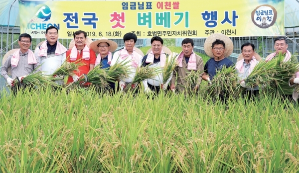 18일 오전 이천시 호법면의 한 비닐하우스 논에서 열린 ‘임금님표 이천쌀 첫 벼 베기’행사에서 엄태준 이천시장(가운데)을 비롯한 참석자들이 기념촬영을 하고 있다.