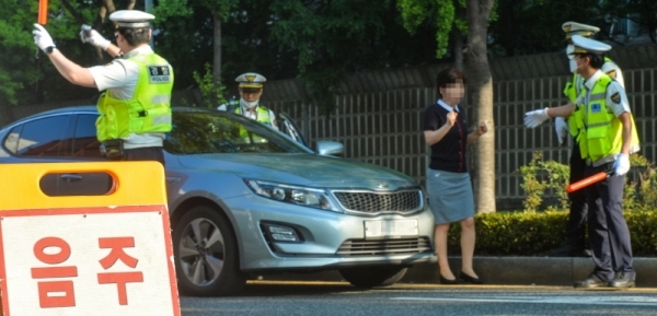 음주운전 단속 기준을 강화한 도로교통법 개정안이 시행된 첫날인 25일 오전 인천 부평구 삼산동 주공아파트 앞 도로에서 한 운전자가 음주감지기에 적발돼 차량에서 내리고 있다.조주현기자