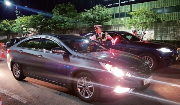 음주운전 단속기준을 강화한 ‘개정 도로교통법’ 시행 첫날인 새벽 1시께 수원 우만동 효성사거리에서 경찰 관계자가 음주단속을 벌이고 있다. 김태희기자