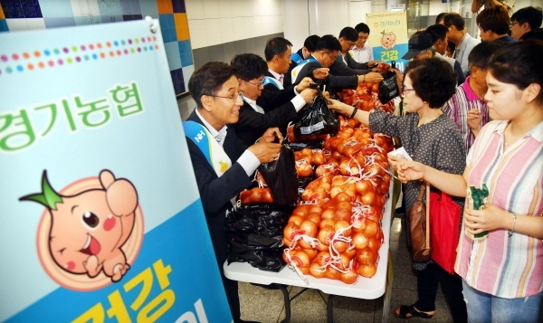16일 수원시청역에서 열린 ‘경기농협 양파 소비촉진 나눔행사’에서 남창현 농협중앙회 경기지역본부장 등 참석자들이 양파 가격하락으로 어려움을 겪고 있는 농민들을 돕기 위해 시민들에게 양파 소비촉진 캠페인을 벌이며 무료로 양파를 나누어 주고 있다.전형민기자