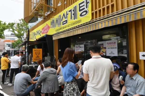 절기상 중복이자 대서를 하루 앞둔 22일 수도권지역에 폭염주의보가 내려진 가운데 수원시내 한 삼계탕집에 몰린 시민들이 삼계탕을 먹기위해 차례를 기다리고 있다. 김시범기자