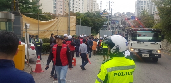 지난 10일 상현동의 한 아파트 단지 진출입로에서 시행사 측과 입주민들이 공사 진행과 관련 대립하고 있다2
