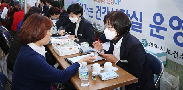 29일 의왕시 부곡동 도깨비 시장에서 ‘우리동네 건강 UP! 찾아가는 건강상담실’이 열린 가운데 주민들이 건강 상담을 받고 있다. 의왕시 제공