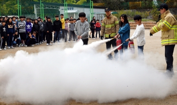 29일 수원시 팔달구 연무초등학교에서 ‘2019 재난대응 안전한국훈련’의 일환으로 열린 지진발생에 따른 건축물 붕괴 및 화재 상황을 가상한 훈련에서 학생들이 소화기 사용법을 체험해 보고 있다.전형민기자