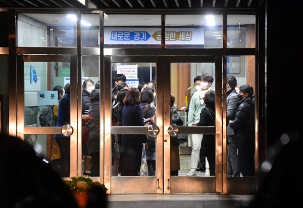 신천지 교회 신도 명단을 확보한 경기도가 이들에 대한 긴급 전수조사에 돌입했다. 26일 오후 경기도청 대회의실에서 늦은 밤까지 전수조사 교육 등을 마친 신천지 관계자 및 공무원들이 귀가하고 있다. 윤원규기자