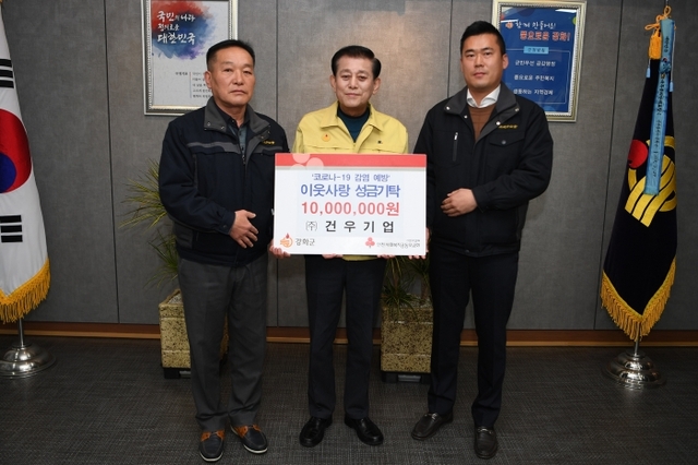 코로나 19 극복을 위한 성금 1천만원을 기탁한 건우기업 관계자와 유천호 강화군수가 기념 촬영을 하고 있다. 강화군 제공