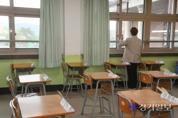 고등학교 3학년 등교 수업 첫날인 20일 오후 코로나19 확진자가 발생해 등교 중지 조치가 내리진 안성시의 한 고등학교 3학년 교실에서 담임교사가 창밖을 바라보고 있다. 시 교육지원청은 
