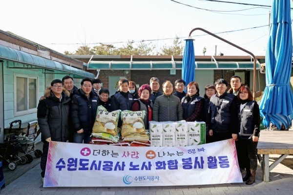 수원도시공사 노사공동봉사단이 지난 2018년12월 장안구의 한 무료급식소 시설에서 봉사활동을한 뒤 기념촬영을 하고 있다.