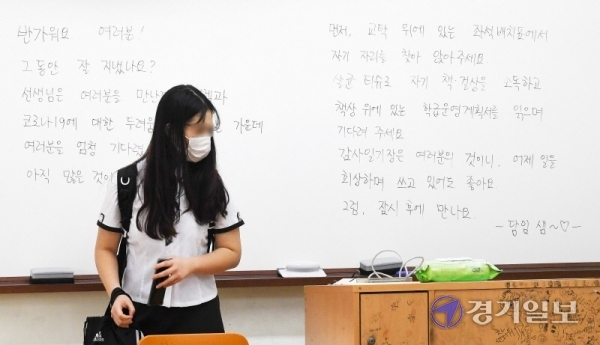 고1·중2·초3∼4학년을 대상으로 한 3차 등교 수업일인 3일 오전 코로나19의 전염확산으로 입학식을 생략한 채 첫 등교한 인천시 서구 청라동의 한 고등학교 1학년 여학생이 칠판에 씌여진 담임교사의 응원글을 배경으로 교탁위의 좌석 배체표를 보고 있다. 장용준기자