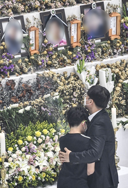 '이천 한익스프레스 물류창고 화재 사고 희생자 합동 영결식'이 열린 20일 오전 이천시 서희청소년문화센터에서 유가족들이 고인의 위패와 영정 앞에서 오열하고 있다. 조주현 기자