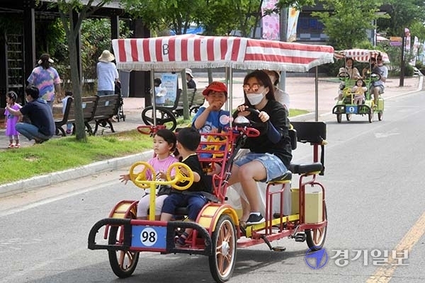 장마가 소강상태를 보이면서 무더위가 찾아 온 27일 오후 주말을 맞아 안성 팜랜드를 찾은 가족단위 나들이객들이 협동자전거를 타고 풍경을 감상하고 있다. 김시범기자