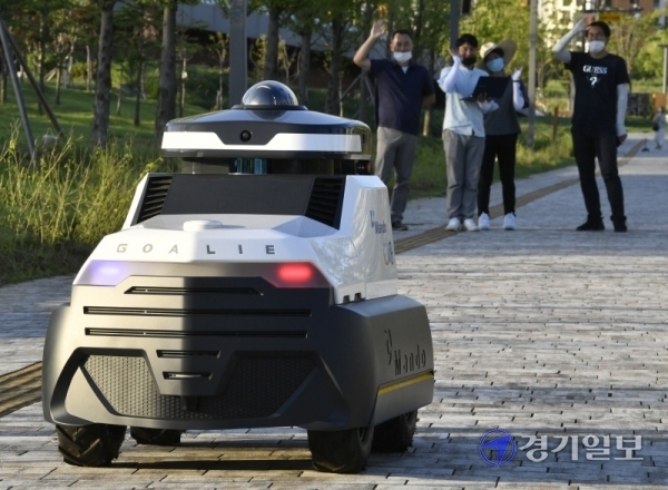 자율주행 순찰로봇 ‘골리’가 15일 오후 시흥시 배곧신도시 생명공원에서 만도 운곡캠퍼스 F3Lab 로봇플랫폼팀 관계자들과 시험운행을 하고 있다. ‘골리‘는 시험운행 기간동안 빅데이터 기술을 활용, 새로운 비전알고리즘을 통해 사물 환경 인식 수준을 높인 뒤 이르면 오는 9월부터 야간 순찰로봇으로서의 임무를 수행할 계획이다. 조주현기자