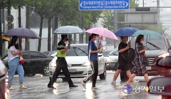 경기, 인천지역에 호우특보가 내려진 22일 오전 수원시 장안구 송죽동 횡단보도에서 출근길 시민 및 학생들이 쏟아지는 빗속에 걸음을 재촉하고 있다. 김시범기자