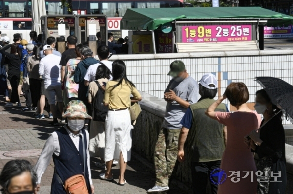 코로나19 장기화로 불황이 계속되는 가운데 19일 오후 고양시 일산동구 한 복권판매점에 일확천금을 꿈꾸는 시민들로 긴 줄이 늘어서 있다. 올 상반기 복권은 2조6천억원어치 팔려나가 2005년 이후 최대 규모의 판매를 기록한 것으로 나타났다.조주현기자