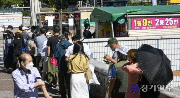 코로나19 장기화로 불황이 계속되는 가운데 19일 오후 고양시 일산동구 한 복권판매점에 일확천금을 꿈꾸는 시민들로 긴 줄이 늘어서 있다. 올 상반기 복권은 2조6천억원어치 팔려나가 2005년 이후 최대 규모의 판매를 기록한 것으로 나타났다.조주현기자