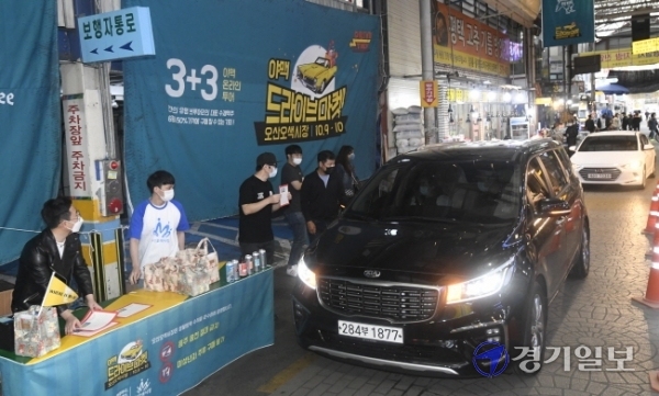10일 오후 오산시 오색시장에서 열린 ‘오산 오색시장 야맥 드라이브 마켓’에서 ‘까마귀 브루잉’ 등 경기지역 브루어리 관계자들이 비대면 방식으로 수제맥주 등을 판매하고 있다. 곽상욱 오산시장은 “코로나19 장기화로 침체된 지역경제 활성화를 위해 오색시장 상인회·문화관광형시장 육성사업단과 전국 최초의 비대면 수제맥주 축제를 준비하게 되었다”라며 “이번 행사에서 포스트 코로나 시대 지역 축제의 가능성을 확인할 수 있을 것”이라고 말했다.조주현기자