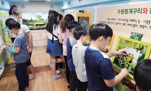‘찾아가는 수원이 환경교실’ 버스에서 다양한 환경교육 체험을 하고 있는 어린이들.<br>