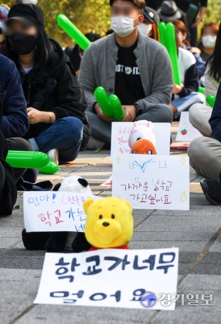 27일 오전 인천시교육청 정문 앞에서 초등학교 원거리 배정 반대집회에 참석한 서구 청라 에일린의 뜰 학부모비대위 회원들이 아이들이 직접 쓴 메세지를 단 인형들을 사이에 놓고 사회적 거리두기를 하고 있다. 장용준기자